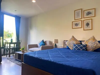 a bedroom with a blue bed and a chair at The Base Central Phuket-B2-Y9B in Ban Rangeng