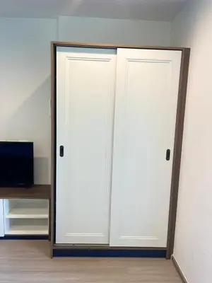 two white doors in a room with a television at The Base Central Phuket-B2-Y9B in Ban Rangeng