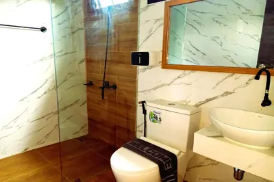 a bathroom with a toilet and a sink and a shower at Resort Thalang in Phuket