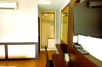 a room with a television and a table with a mirror at Resort Thalang in Phuket