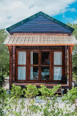 a small wooden house with a window in a field at Laleuca At Laemhad Kohyaoyai in Ko Yao Yai
