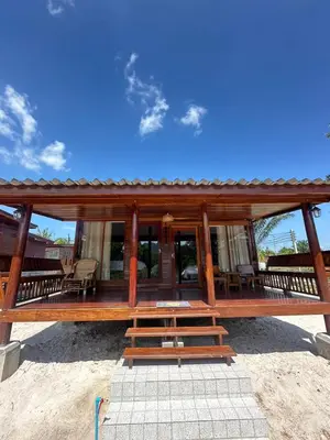 a wooden pavilion with a picnic table and chairs at Laleuca At Laemhad Kohyaoyai in Ko Yao Yai