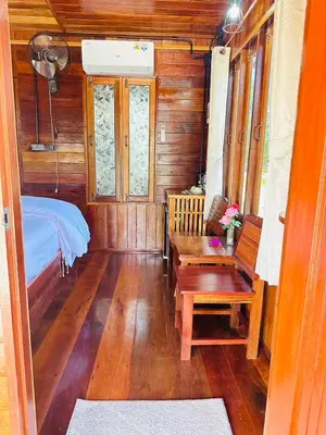 a small room with a bed and a wooden floor at Laleuca At Laemhad Kohyaoyai in Ko Yao Yai