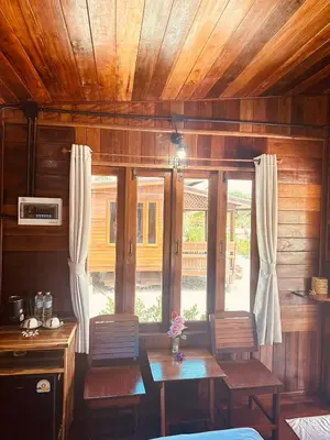 a dining room with a table and chairs and a window at Laleuca At Laemhad Kohyaoyai in Ko Yao Yai