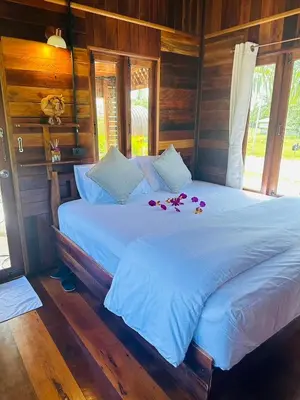 a bed in a room with flowers on it at Laleuca At Laemhad Kohyaoyai in Ko Yao Yai
