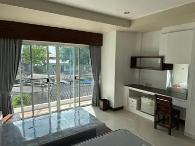 a living room with a large window with a view at Bestin Kata in Karon Beach