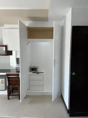a room with a door leading to a kitchen at Bestin Kata in Karon Beach