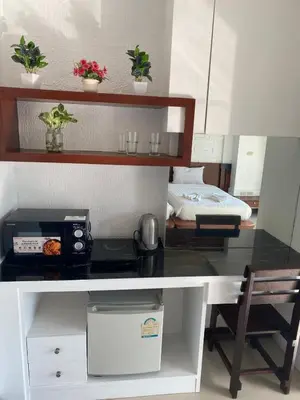 a kitchen with a counter top and a table at Bestin Kata in Karon Beach