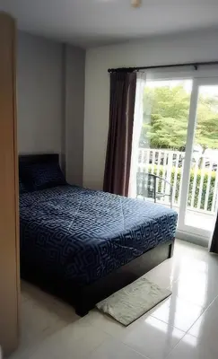 a bedroom with a bed and a window with a balcony at Supalai Park Phuket City 2 bedrooms for rent in Phuket Town