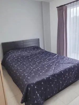 a bed with a black comforter in a bedroom at Supalai Park Phuket City 2 bedrooms for rent in Phuket Town
