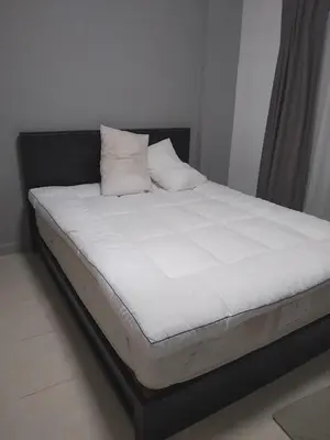a bed with white sheets and pillows in a room at Supalai Park Phuket City 2 bedrooms for rent in Phuket Town