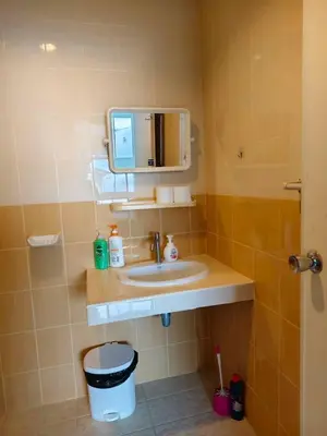 a bathroom with a sink and a mirror at Banana Bunkhouse Hostel in Rawai Beach