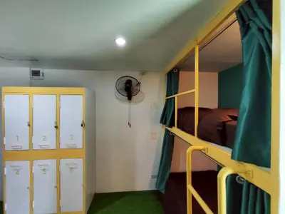 a dorm room with a bunk bed and a bedroom with a bunk bed at Banana Bunkhouse Hostel in Rawai Beach