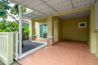 an empty porch of a house with yellow walls at OldTown Home Phuket 3min walk Central Festival in Ban Rangeng