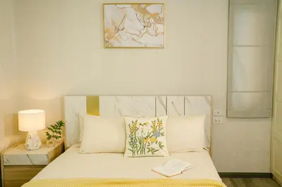 a bedroom with a bed with a book on it at Strelitzia Tropical Living at Title Nai Yang in Nai Yang Beach