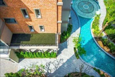an aerial view of a swimming pool in front of a building at Strelitzia Tropical Living at Title Nai Yang in Nai Yang Beach