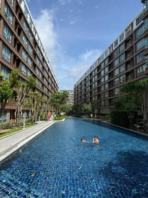 two people swimming in a swimming pool in a building at Dcondo Creek Phuket 2BR in Kathu
