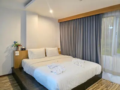 a bedroom with a bed with towels on it at Le Moon in Patong Beach