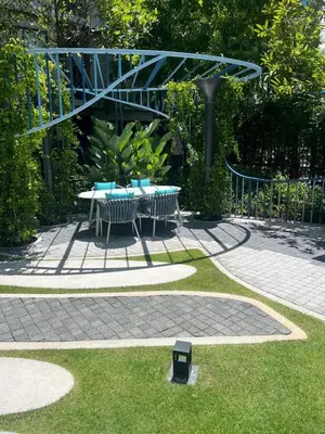 a patio with a table and chairs in a garden at Luxury cosy condo in Kathu centre in Kathu