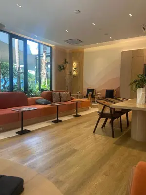 a lobby with a couch and tables and windows at Luxury cosy condo in Kathu centre in Kathu