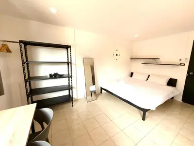 a bedroom with a bed and a mirror in it at Patong Canal Villa 305 in Patong Beach