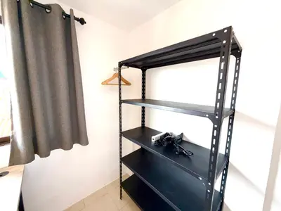 a black shelf in a room with a curtain at Patong Canal Villa 305 in Patong Beach