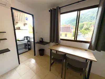 a dining room with a table and a window at Patong Canal Villa 305 in Patong Beach