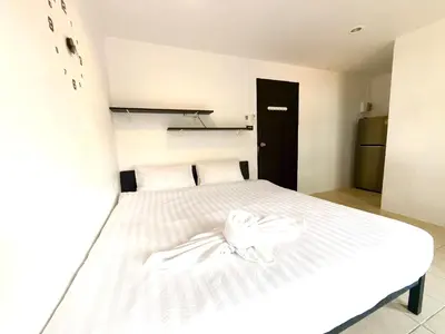 a white bed with a white bow on it at Patong Canal Villa 305 in Patong Beach