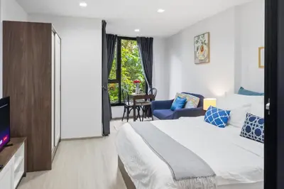 a hotel room with a bed and a tv at Luxury Resort Style 1 Bedroom Studio near Central in Phuket Town
