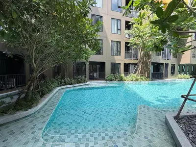 a swimming pool in front of a building at Luxury Resort Style 1 Bedroom Studio near Central in Phuket Town