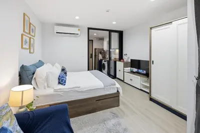 a bedroom with a bed and a living room at Luxury Resort Style 1 Bedroom Studio near Central in Phuket Town