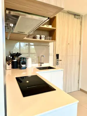 a kitchen with a sink and a counter top at Skypark Laguna 2 Bedroom Apartment in Laguna Phuket