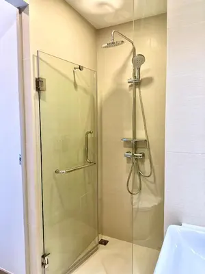 a shower with a glass door in a bathroom at Skypark Laguna 2 Bedroom Apartment in Laguna Phuket