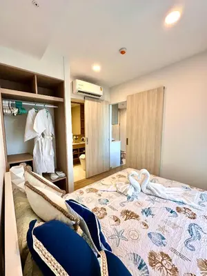 a bedroom with a large bed and a bathroom at Skypark Laguna 2 Bedroom Apartment in Laguna Phuket