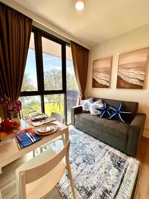a living room with a couch and a table at Skypark Laguna 2 Bedroom Apartment in Laguna Phuket