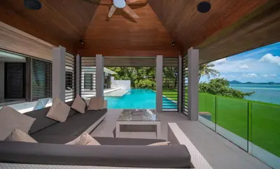 an outdoor living room with a couch and a pool at Villa Serenity -30 meter Pool & 6 Bedroom with Cinema Room and Gym in Ko Lek