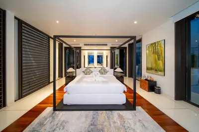 a bedroom with a large white bed with glass doors at Villa Serenity -30 meter Pool & 6 Bedroom with Cinema Room and Gym in Ko Lek