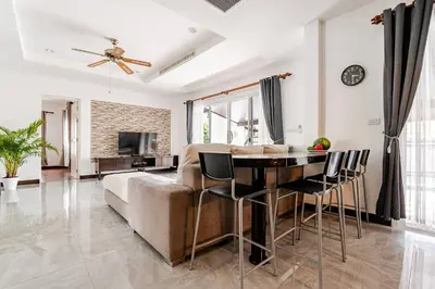 a living room with a couch and a table at Cozy Pool Villa near Kamala - 12 min to the Beach in Kamala Beach