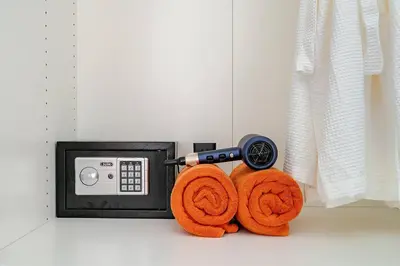 a hair dryer and two orange towels next to a microwave at Cozy Pool Villa near Kamala - 12 min to the Beach in Kamala Beach