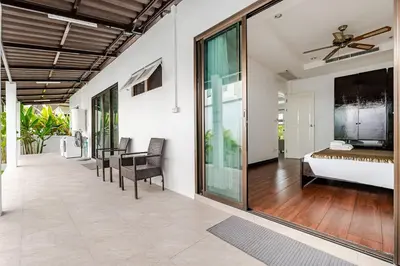 a bedroom with a bed and a table and chairs at Cozy Pool Villa near Kamala - 12 min to the Beach in Kamala Beach