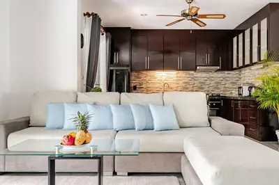 a living room with a white couch with blue pillows at Cozy Pool Villa near Kamala - 12 min to the Beach in Kamala Beach