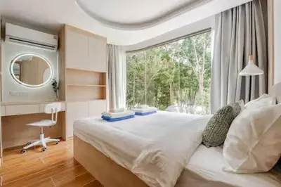 a bedroom with a large bed and a window at Чудесная видовая квартира Fantasea пляж Камала in Kamala Beach