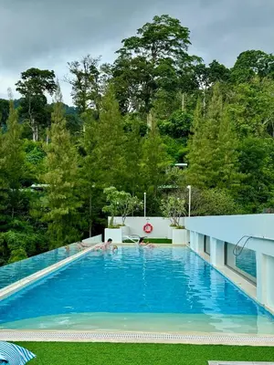 a large blue swimming pool with people in it at Чудесная видовая квартира Fantasea пляж Камала in Kamala Beach