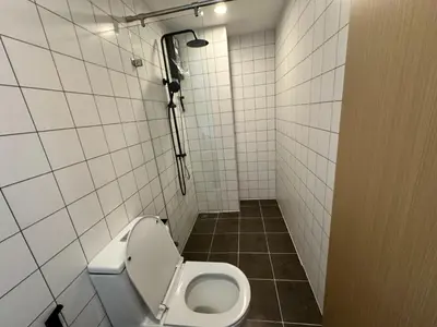 a bathroom with a white toilet in a stall at Чудесная видовая квартира Fantasea пляж Камала in Kamala Beach