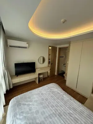 a bedroom with a bed and a flat screen tv at Чудесная видовая квартира Fantasea пляж Камала in Kamala Beach