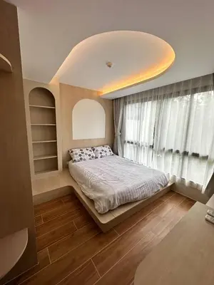 a bedroom with a bed and a large window at Чудесная видовая квартира Fantasea пляж Камала in Kamala Beach
