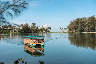 a small boat on the water on a lake at Cassia Phuket, part of Banyan Group in Bang Tao Beach