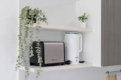 a kitchen shelf with a toaster and aperature at Mountain view apartment near Kata beach in Kata Beach