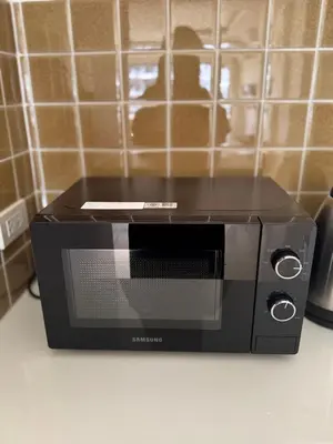 a black toaster oven sitting on top of a counter at The President Park Condo Nanai, Patong, Phuket in Patong Beach