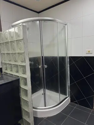 a shower with a glass door in a bathroom at The President Park Condo Nanai, Patong, Phuket in Patong Beach